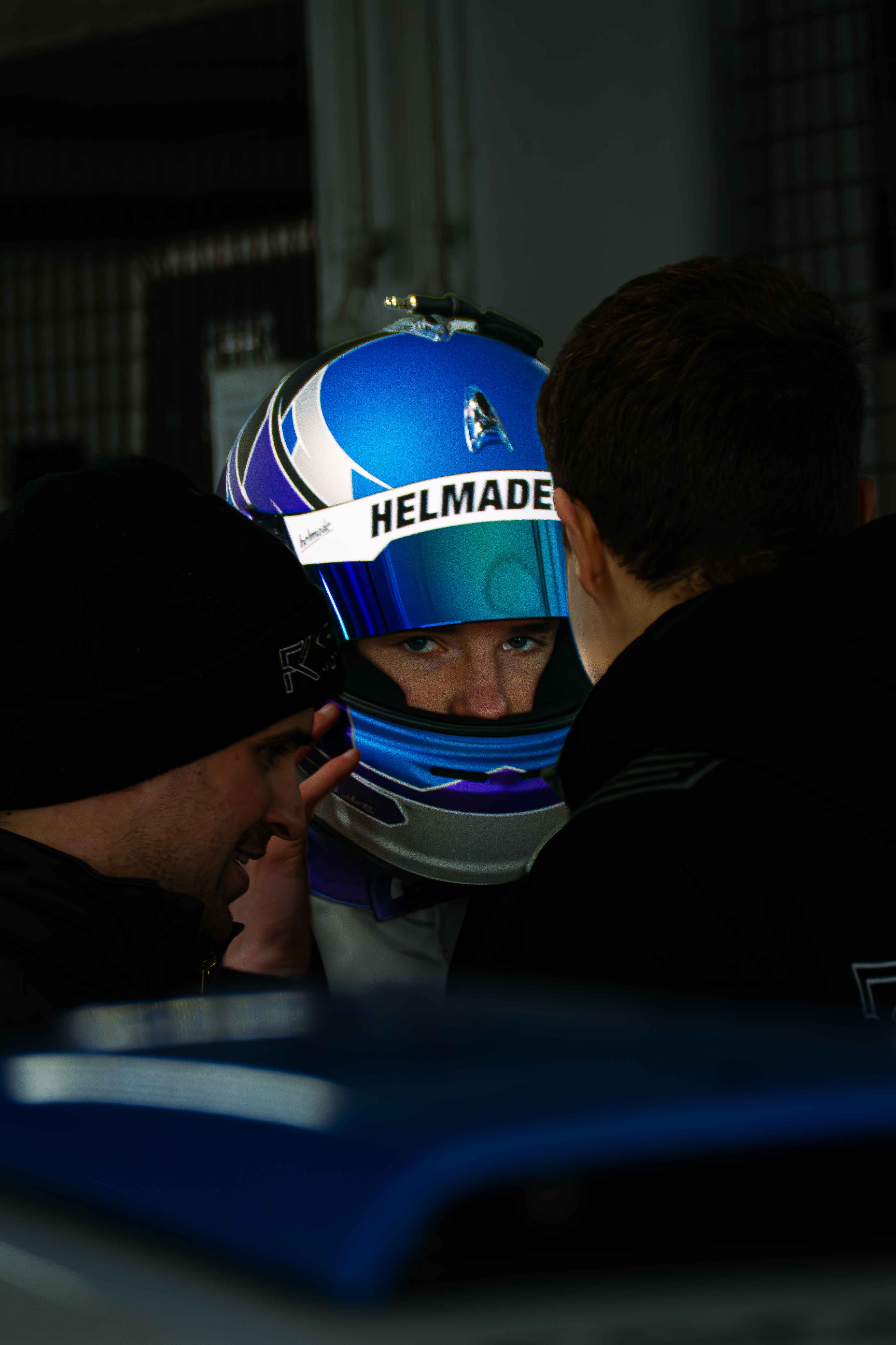 Malte Jaekel in his helmet talking with the team
