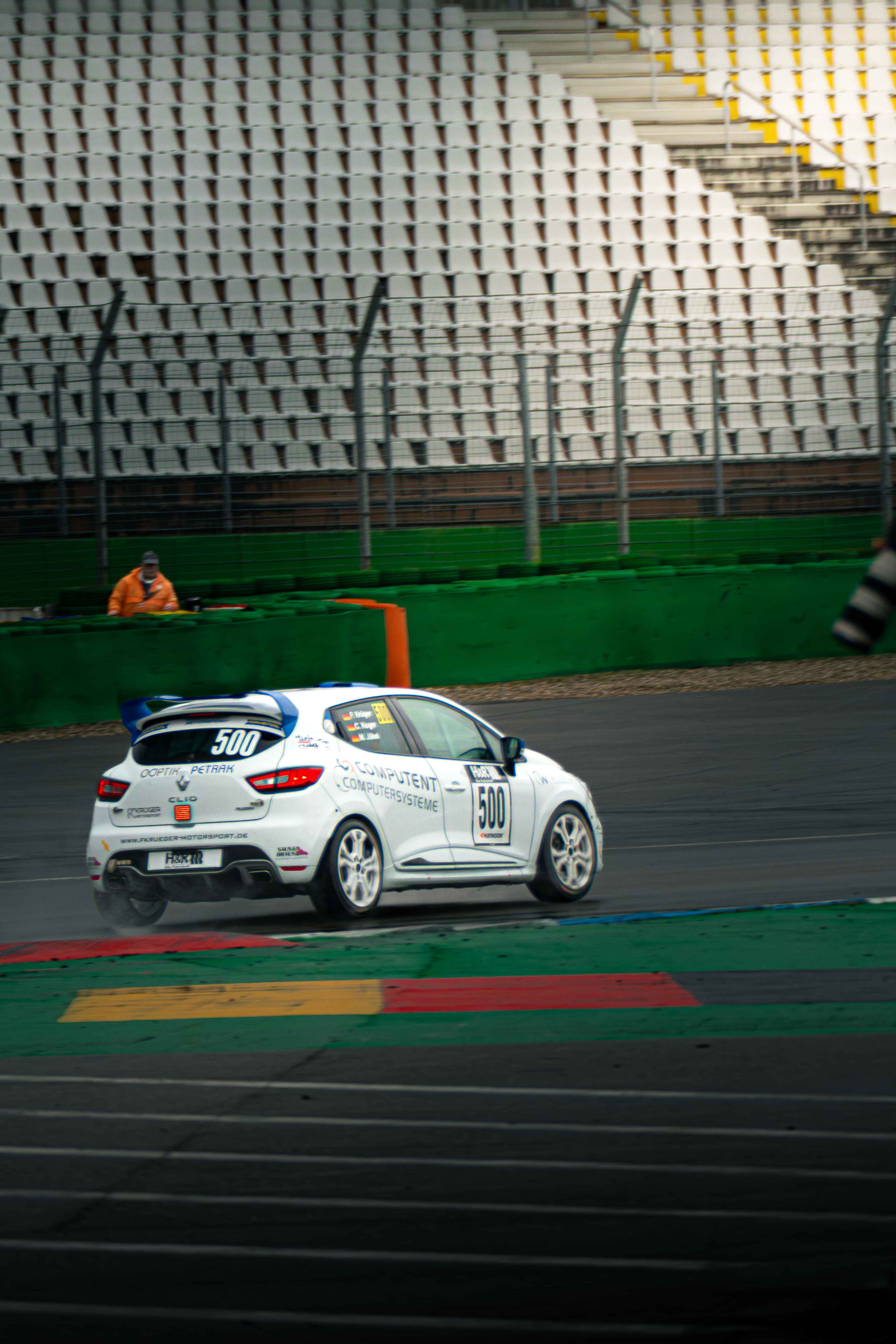 Clio Cup race car cornering on a wet circuit